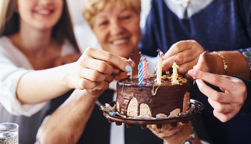 Senior woman celebrating birthday with family and friends