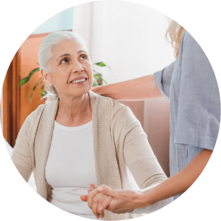 hospice patient sitting at home couch talking to caring hospice nurse