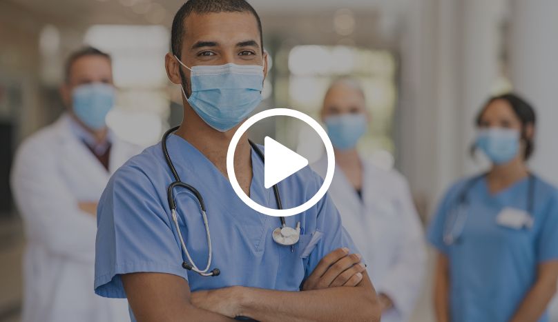 Four nurses standing with smiles and masks on