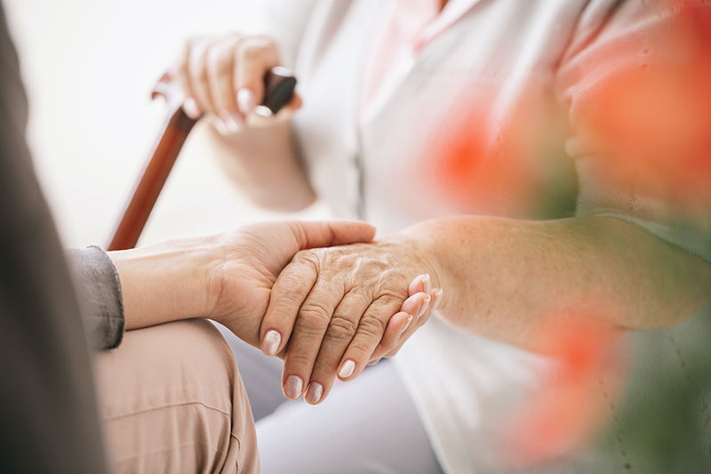 Hospice patient holding hands with hospice nurse los angeles