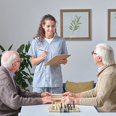hospice worker talking to senior hospice patients at facility