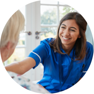 hospice worker smiling at hospice patient at room in hospice patient house